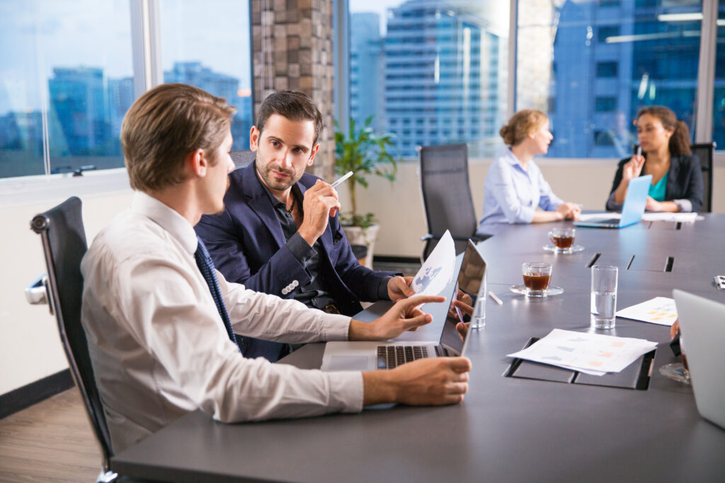 Business colleagues discussing documents at an office table